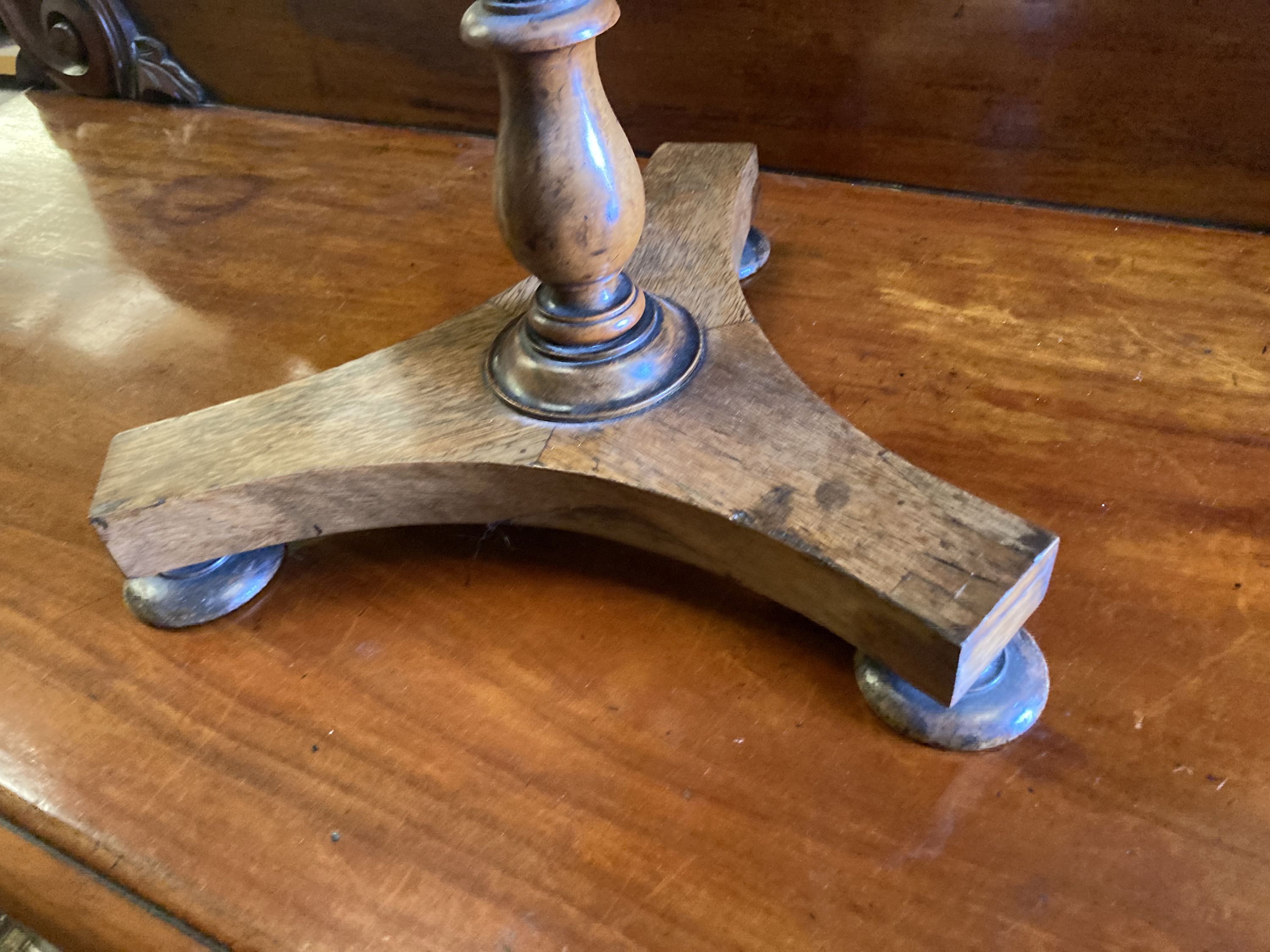 An early Victorian circular rosewood candlestand with galleried shelf on platform base, diameter 35cm, height 72cm